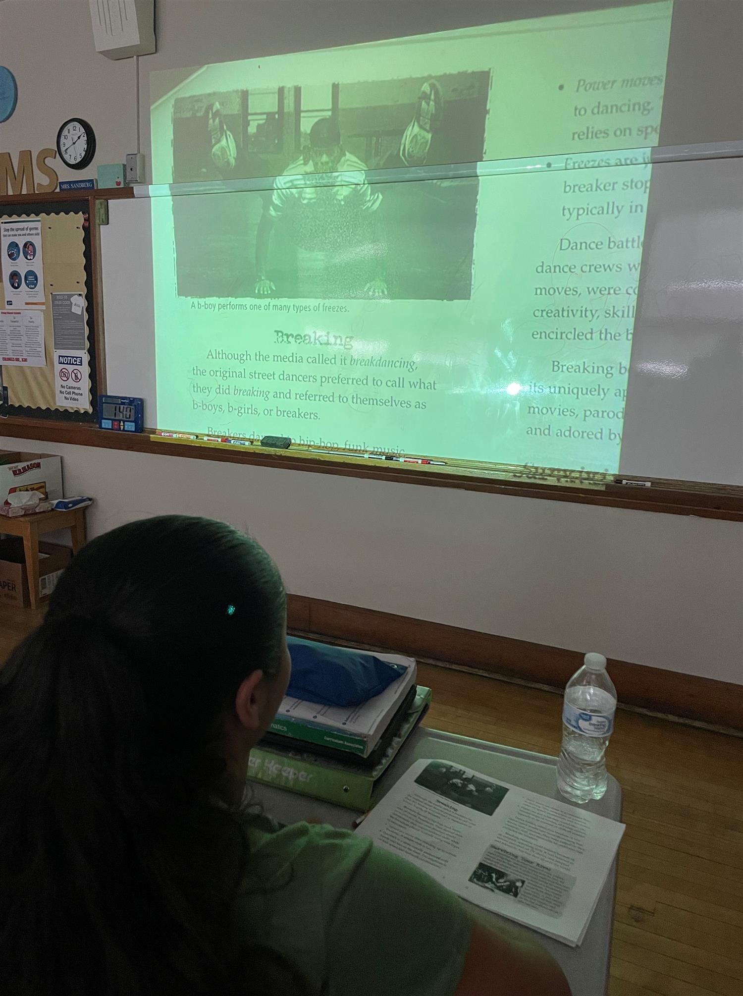 Photo of student looking at a projected image detailing the four pillars of hip hop.